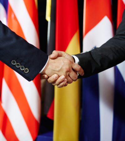 Close-up of two politicians in suits shaking hands
