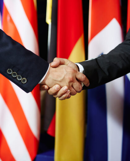 Close-up of two politicians in suits shaking hands